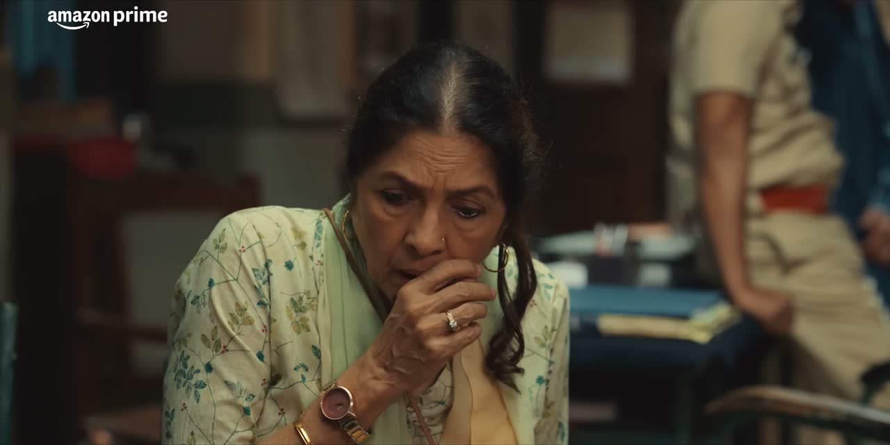 A woman seated in a police station interior, from Mast Mein Rehne Ka